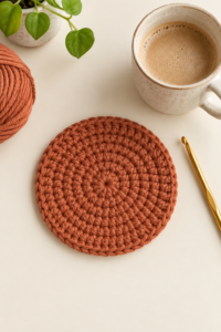 Finished terracotta single crochet coaster lying flat