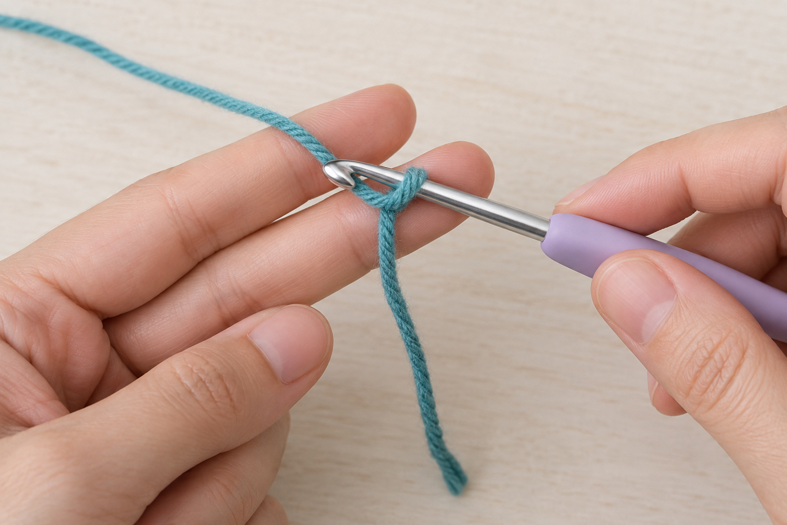 Crochet hook pulling a teal working-yarn loop through a loop held over two fingers